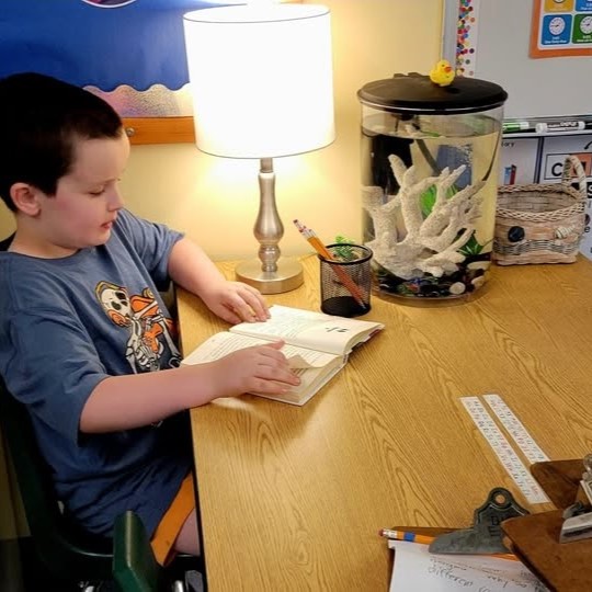 student reading by a fish tank
